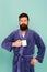 Bearded man in bathrobe with mug. Breakfast concept. Man with beard in blue bathrobe enjoy morning coffee or tea. Guy in