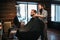Bearded man in black salon cape visit barbershop