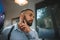 Bearded man on a blurred background. Handsome man touching new beard in a barbershop. Hipster style concept. Copy space.