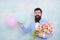 Bearded man in bow tie with tulip flowers. love date with flowers. Happy Birthday. womens day. Formal mature businessman