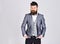 Bearded man in business suit on grey background, copy space. hipster has confindent look. beard care and barber
