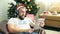 Bearded man in Christmas cap has videocall with pad