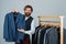 Bearded man collector vintage clothes showing formal suit, famous brand concept