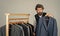 Bearded man collector vintage clothes showing formal suit, retro stock concept