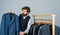 Bearded man collector vintage clothes showing formal suit, second hand store concept