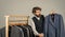 Bearded man collector vintage clothes showing formal suit, second hand store concept