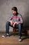 Bearded man in colorful shirt sitting on a deck