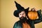 Bearded man cook in Halloween hat with pumpkin. Design for Halloween banner. Handsome Halloween man with pumpkin in hand