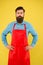 Bearded man in cook uniform. Mature shop assistant. Chef in red apron. Restaurant staff. Cooking hobby. Lots of delivery