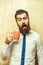 Bearded man with curious face look into tea, coffee cup