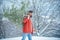 Bearded Man cutting Christmas tree. Bearded man with freshly cut down Christmas tree in forest. Young woodcutter winter