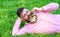 Bearded man with daisy flowers in beard lay on meadow, lean on hand, grass background. Flirt concept. Guy with bouquet