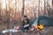 Bearded man enjoys company of his dog outdoors at a camping place in late autumn