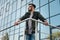 Bearded man in eyeglasses leaning on railing at office building