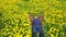 Bearded man in field of yellow dandelions lies resting in a field of dandelions