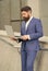 Bearded man in formal suit check up electronic mail in laptop using internet urban outdoors, email