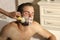 Bearded man getting shaving foam applied on beard with brush