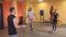 Bearded man and girl jump on a rope in the gym under the supervision of a trainer, warm up before training boxing