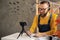 bearded man in glasses business owner sits in halloween decorated home office. Writes with a pen on paper. selling goods