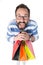 Bearded Man with glasses holds bunch of shopping bags. Man with crazy surprised face with shopping bags. Crazy Shopping concept.