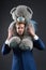 Bearded man with grey teddy bear. Businessman hold big animal toy. Fashion manager with toy gift or present. Birthday or anniversa