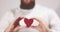 Bearded man hands holding Heart shape Love and Health symbol