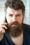 Bearded man hold mobile phone. Hipster bearded communicate smartphone call. Mobile communication. Communication concept