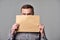 Bearded man holding blank brown envelope