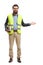 Bearded man holding books, wearing safety vest and gesturing welcome with hand