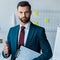 Bearded man holding clipboard with resume letters and showing thumb up