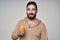 Bearded man holding a glass of orange juice