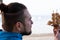 Bearded man holding ship model with seashells