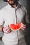 Bearded man holds in hands bitten off slice of watermelon