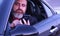 Bearded man inside car with phone