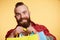 Bearded man, long beard. Brutal caucasian with moustache holding shopping packages