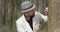 Bearded man looking at green moss through loupe