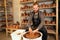 A bearded man molding a vase of clay on a potter`s wheel in a pottery workshop. potter, clay, vase, pottery and potter