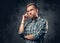 Bearded man over grey background.