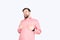 Bearded man in a pink checked shirt laughs. Young unshaven guy funny