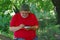 Bearded man playing mini-chess with himself in a park