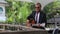 bearded man plays guitar by wooden barrier