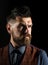 Bearded man in shirt and vintage suede waistcoat. Side view portrait of attractive brutal bearded guy. Advertising barbershop