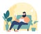 Bearded man sitting on sofa with laptop, relaxing at home, casual indoor setting. Comfortable home office and freelance