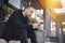 Bearded man sitting on a step and looking at mobile phone screen.