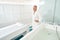 Bearded man standing by massage table in spa salon