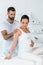Bearded man standing near attractive pregnant woman in spa center