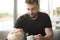 Bearded man stirs coffee in a restaurant