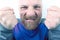 Bearded man with strong emotions and with clenched fists closeup on white background