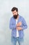 Bearded man with stylish beard hair button fashion plaid shirt in casual style blue background, trendy