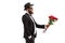 Bearded man in a suit giving a bouquet of red roses